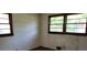 Bedroom with original hardwood floors and two large windows at 1888 Delphine Dr, Decatur, GA 30032