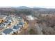 Aerial view shows a residential neighborhood with a lake and a row of houses along a street at 3945 Starwood Dr, Cumming, GA 30028