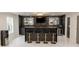 Finished basement featuring a modern bar area with barstool seating, custom lighting, and sleek countertops at 3945 Starwood Dr, Cumming, GA 30028