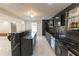 Modern bar area with sleek black countertops, custom cabinetry, and ample storage space at 3945 Starwood Dr, Cumming, GA 30028