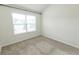 The carpeted bedroom has natural light from the window and neutral walls, offering a blank canvas at 3945 Starwood Dr, Cumming, GA 30028