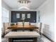 Elegant dining room featuring a modern chandelier, dark accent wall, and stylish wood table with seating at 3945 Starwood Dr, Cumming, GA 30028
