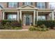 Inviting front porch featuring a decorative wreath, brick steps, and manicured landscaping at 3945 Starwood Dr, Cumming, GA 30028