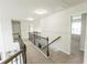 Upstairs hallway features iron railing, neutral walls, and access to bedrooms and other living areas at 3945 Starwood Dr, Cumming, GA 30028