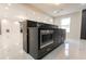 This kitchen boasts a black marble island with built-in stainless steel microwave and sleek marble countertops at 3945 Starwood Dr, Cumming, GA 30028