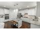 Kitchen island with stainless steel appliances, white cabinets and granite countertops at 3945 Starwood Dr, Cumming, GA 30028