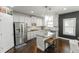 Kitchen with stainless steel appliances, white cabinets, an island, and modern lighting at 3945 Starwood Dr, Cumming, GA 30028