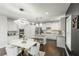 Open kitchen featuring an island with seating, stainless steel appliances, and white cabinetry at 3945 Starwood Dr, Cumming, GA 30028