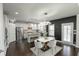 Eat-in kitchen with white cabinets, stainless steel appliances, an island, and modern lighting at 3945 Starwood Dr, Cumming, GA 30028