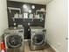 A well-organized laundry room equipped with modern front-load washer and dryer units at 3945 Starwood Dr, Cumming, GA 30028