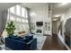 Open-concept living room with fireplace, built-ins, large windows, and modern decor at 3945 Starwood Dr, Cumming, GA 30028