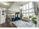 Open-concept living room with fireplace, large windows, and comfortable seating, seamlessly connected to the kitchen at 3945 Starwood Dr, Cumming, GA 30028