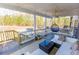Relax on the covered porch with comfortable seating and views of nature at 3945 Starwood Dr, Cumming, GA 30028