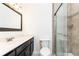 Updated bathroom featuring a sleek vanity, modern fixtures, and a glass-enclosed shower at 5672 Kingsport Dr # 4, Atlanta, GA 30342