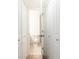 Bright half bathroom featuring a standard toilet between two white doors at 5672 Kingsport Dr # 4, Atlanta, GA 30342