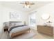 Bright staged bedroom with ceiling fan, dresser, window and neutral decor at 5672 Kingsport Dr # 4, Atlanta, GA 30342