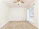Unfurnished bedroom with large window and ceiling fan at 5672 Kingsport Dr # 4, Atlanta, GA 30342