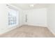 Bedroom with neutral carpet, window with blinds, and mirrored door for access at 5672 Kingsport Dr # 4, Atlanta, GA 30342