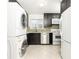 Stylish kitchen featuring sleek black cabinetry, stainless steel appliances, and a convenient washer/dryer setup at 5672 Kingsport Dr # 4, Atlanta, GA 30342