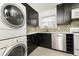 Updated kitchen boasting stainless steel appliances, dark cabinetry, and mosaic tile backsplash at 5672 Kingsport Dr # 4, Atlanta, GA 30342