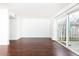 Bright living room featuring sliding glass door and wood floors overlooking outdoor patio at 5672 Kingsport Dr # 4, Atlanta, GA 30342
