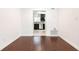 Bright living room featuring hardwood floors leading to a modern kitchen with stainless steel appliances at 5672 Kingsport Dr # 4, Atlanta, GA 30342