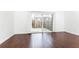 Bright living room featuring sliding glass door and wood floors overlooking outdoor patio at 5672 Kingsport Dr # 4, Atlanta, GA 30342