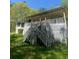 View of the back exterior of the home with a porch and stairs leading up to it at 1905 Rockmart Rd, Villa Rica, GA 30180