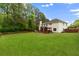 Expansive backyard featuring a well-maintained lawn and wooden privacy fence at 160 Fieldstone Dr, Powder Springs, GA 30127