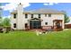 Spacious backyard with a lush green lawn, deck, screen porch, and pergola at 160 Fieldstone Dr, Powder Springs, GA 30127