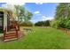 Well-manicured backyard with a wooden deck, a screened porch, and a privacy fence at 160 Fieldstone Dr, Powder Springs, GA 30127