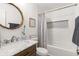 Stylish bathroom with marble countertop, decorative mirror, and tiled shower with a built-in niche at 160 Fieldstone Dr, Powder Springs, GA 30127