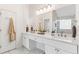 The bathroom has dual sinks, white marble countertops, and a large, frameless mirror at 160 Fieldstone Dr, Powder Springs, GA 30127