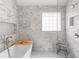 This bathroom features marble tile throughout, a glass-enclosed shower, and a free-standing bathtub at 160 Fieldstone Dr, Powder Springs, GA 30127