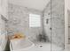 This bathroom features marble tile throughout, a glass-enclosed shower, and a free-standing bathtub at 160 Fieldstone Dr, Powder Springs, GA 30127