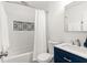 This stylish bathroom features a bathtub/shower combo and a blue vanity with gold hardware at 160 Fieldstone Dr, Powder Springs, GA 30127