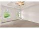 The bonus room is spacious with neutral carpet, a ceiling fan, and plenty of light from two windows at 160 Fieldstone Dr, Powder Springs, GA 30127