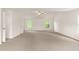 This large bonus room has neutral carpet, vaulted ceiling, and many large windows at 160 Fieldstone Dr, Powder Springs, GA 30127