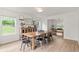 Open dining room featuring a long wooden table, stylish metal chairs, and natural light from a window at 160 Fieldstone Dr, Powder Springs, GA 30127
