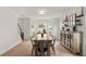 Open dining room featuring a long wooden table, stylish metal chairs, and natural light from bay windows at 160 Fieldstone Dr, Powder Springs, GA 30127