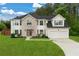 Charming two-story home featuring a lush green lawn, brick facade, and attached two-car garage at 160 Fieldstone Dr, Powder Springs, GA 30127