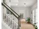 Bright hallway with a staircase, light hardwood floors, and a decorative potted plant at 160 Fieldstone Dr, Powder Springs, GA 30127