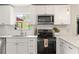 Bright kitchen featuring white cabinets, stainless steel appliances, and a window view at 160 Fieldstone Dr, Powder Springs, GA 30127