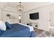 This bedroom includes wood floors, a white dresser, and large wall-mounted television at 160 Fieldstone Dr, Powder Springs, GA 30127