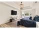 This main bedroom boasts wood floors, tray ceiling, and large window overlooking the front yard at 160 Fieldstone Dr, Powder Springs, GA 30127