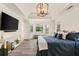 Spacious main bedroom featuring a tray ceiling, large windows, and a TV at 160 Fieldstone Dr, Powder Springs, GA 30127