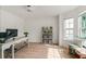 Well-lit home office with a modern desk, shelving, and a comfortable window seat at 160 Fieldstone Dr, Powder Springs, GA 30127
