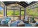 Cozy screened sunroom with comfortable seating for enjoying the outdoor views at 160 Fieldstone Dr, Powder Springs, GA 30127