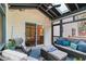 Relaxing screened-in porch with skylights, ceiling fan, and comfortable wicker furniture at 160 Fieldstone Dr, Powder Springs, GA 30127