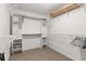 The closet has white shelves and drawers, and metal racks for hanging clothes at 160 Fieldstone Dr, Powder Springs, GA 30127